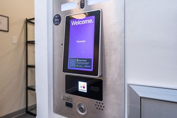 A close up of a refrigerator door with a welcome screen on it
